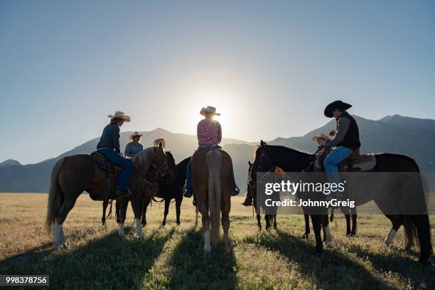 backlit horse riders on horses at dawn sunrise - trail ride stock pictures, royalty-free photos & images