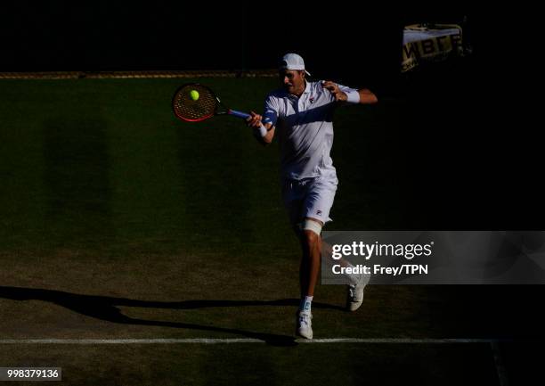 John Isner of the United States in action against Milos Raonic of Canada in the gentlemen's quarter finals at the All England Lawn Tennis and Croquet...