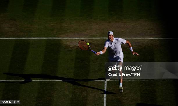 John Isner of the United States in action against Milos Raonic of Canada in the gentlemen's quarter finals at the All England Lawn Tennis and Croquet...