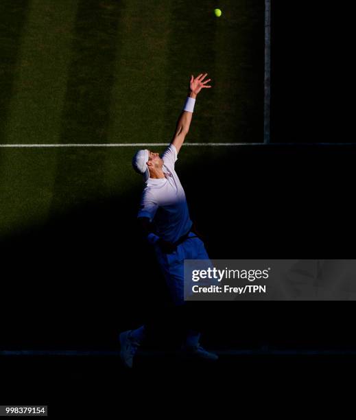John Isner of the United States in action against Milos Raonic of Canada in the gentlemen's quarter finals at the All England Lawn Tennis and Croquet...