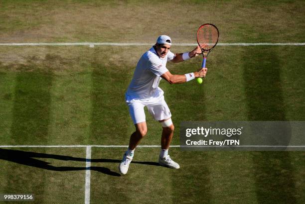 John Isner of the United States in action against Milos Raonic of Canada in the gentlemen's quarter finals at the All England Lawn Tennis and Croquet...