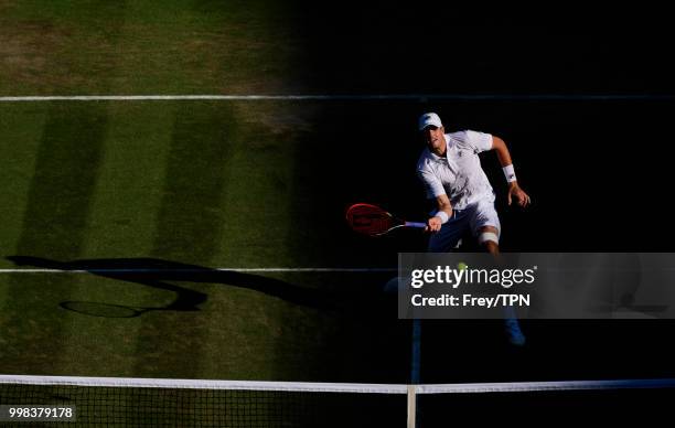 John Isner of the United States in action against Milos Raonic of Canada in the gentlemen's quarter finals at the All England Lawn Tennis and Croquet...