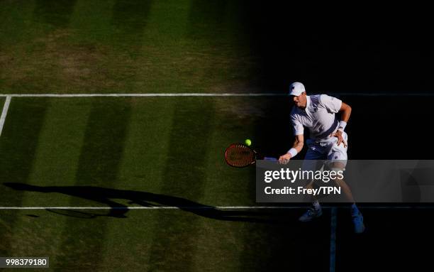 John Isner of the United States in action against Milos Raonic of Canada in the gentlemen's quarter finals at the All England Lawn Tennis and Croquet...