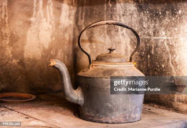 a kettle sitting on top of a wood stove - kettle stock pictures, royalty-free photos & images
