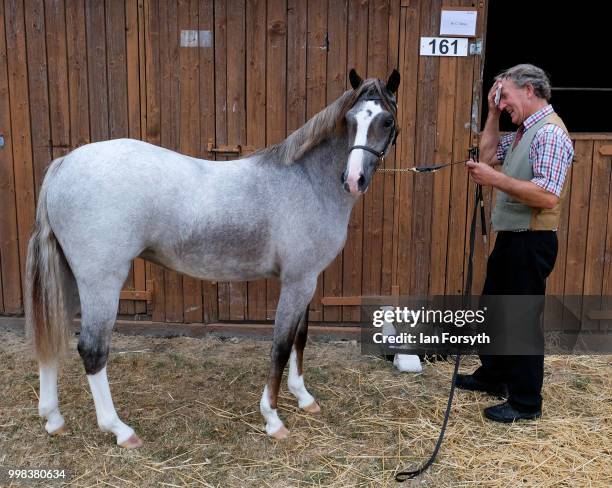 Man stands with his horse outside the stables during the final day of the 160th Great Yorkshire Show on July 12, 2018 in Harrogate, England. First...