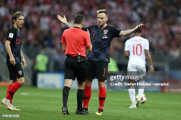 Ivan Rakitic of Croatia Luka Modric of Croatia referee Cuneyt Cakir of turky during the 2018 FIFA World Cup Russia Semi Final match between England...