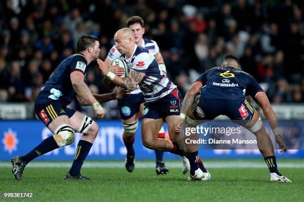 Billy Meakes of the Rebels fends off Liam Squire of the Highlanders during the round 19 Super Rugby match between the Highlanders and the Rebels at...