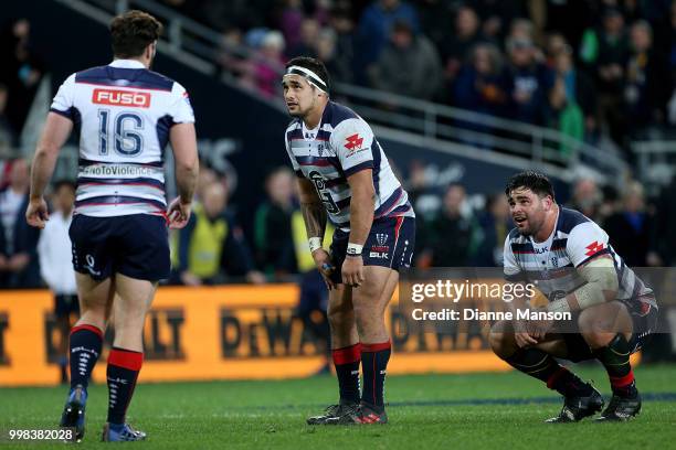 Nathan Charles, Tetera Faulkner and Jermaine Ainsley of the Rebels look dejected after the round 19 Super Rugby match between the Highlanders and the...