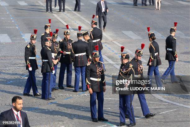 Republican Guards stand as preparations are made for the annual Bastille Day military parade on the Champs-Elysees avenue in Paris on July 14, 2018.