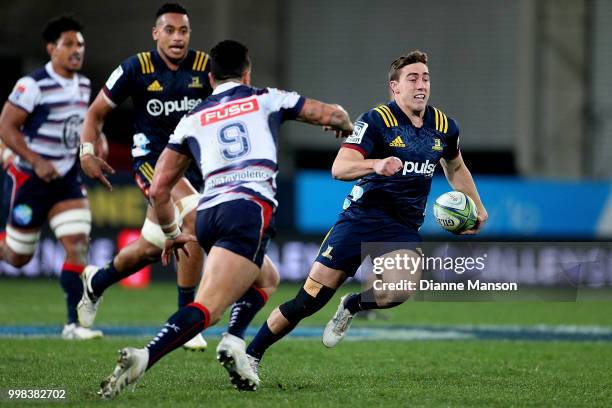 Josh McKay of the Highlanders makes a break during the round 19 Super Rugby match between the Highlanders and the Rebels at Forsyth Barr Stadium on...