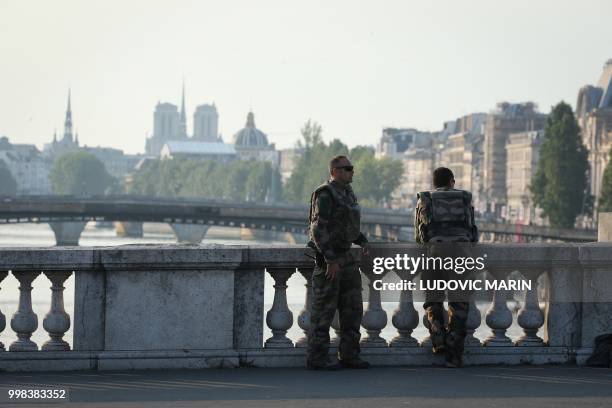 French soldiers from the Sentinelle security operation patrol near Notre-Dame de Paris Cathedral in central Paris on July 14, 2018 as preparations...