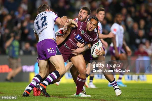 Martin Taupau of the Sea Eagles is tackled during the round 18 NRL match between the Manly Sea Eagles and the Melbourne Storm at Lottoland on July...