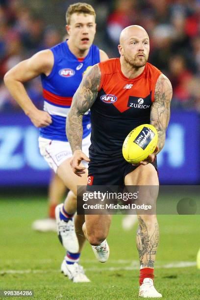 Nathan Jones of the Demons handballs during the round 17 AFL match between the Melbourne Demons and the Western Bulldogs at Melbourne Cricket Ground...