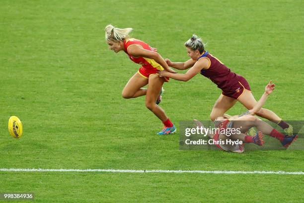 Paige Parker of the Suns is tackled during the AFLW Winter Series match between the Gold Coast Suns and the Brisbane Lions at Metricon Stadium on...