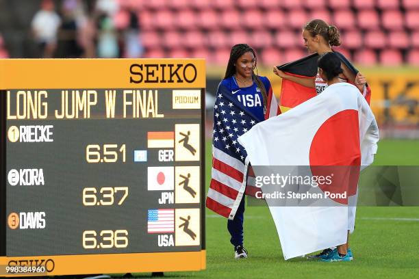 Tara Davis of The USA, Lea-Jasmin Riecke of Germany and Ayaka Kora of Japan celebrate after winning medals in the final of the women's long jump on...