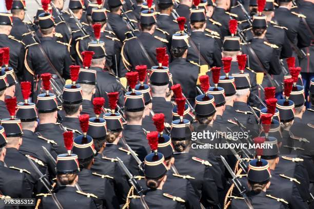French Republican Guards are seen during preparations for the annual Bastille Day military parade on the Champs-Elysees avenue in Paris on July 14,...