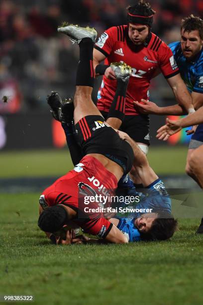 Richie Mo'unga of the Crusaders is tackled by Matt Moulds of the Blues during the round 19 Super Rugby match between the Crusaders and the Blues at...