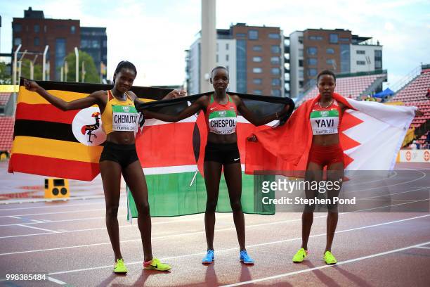 Peruth Chemutai of Uganda, Celiphine Chepteek Chepsol of Kenya and Winfred Mutile Yavi of Bahrain celebrate after winning medals in the final of the...