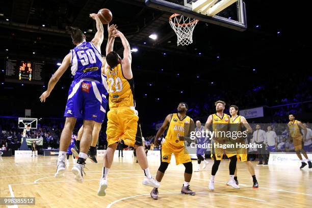 Shane Temara of the Saints and Thane O'Leary of the Mountainairs compete for a rebound during the NZNBL match between Wellington Saints and Taranaki...