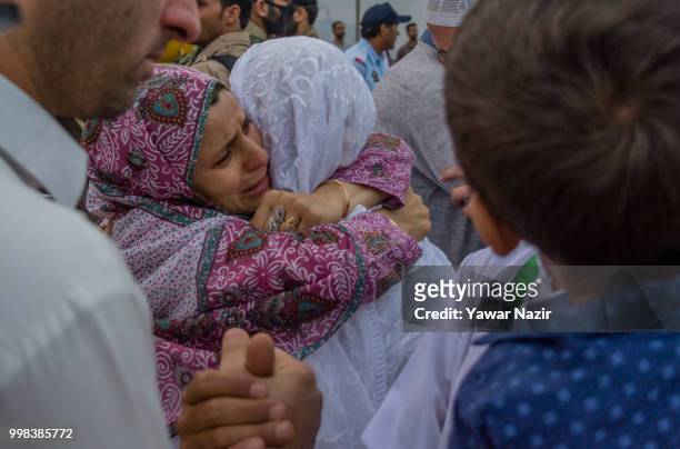 Kashmiri Muslim hajj pilgrim hugs her relative before departing for the annual Hajj pilgrimage to Mecca on July 14, 2018 in Srinagar, the summer...
