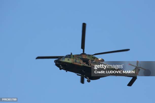 Caiman Helicopter of the French land forces flies during preparations for the annual Bastille Day military parade on the Champs-Elysees avenue in...