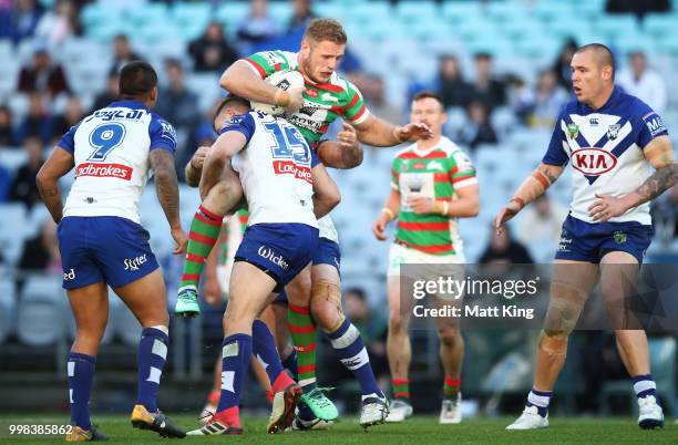Thomas Burgess of the Rabbitohs is tackled during the round 18 NRL match between the Canterbury Bulldogs and the South Sydney Rabbitohs at ANZ...