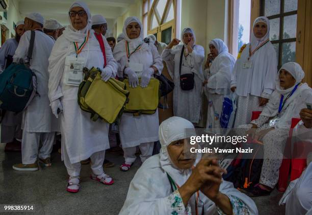 Kashmiri Muslim Hajj pilgrims wait at Hajj house to board buses before departing for the annual Hajj pilgrimage to Mecca on July 14, 2018 in...
