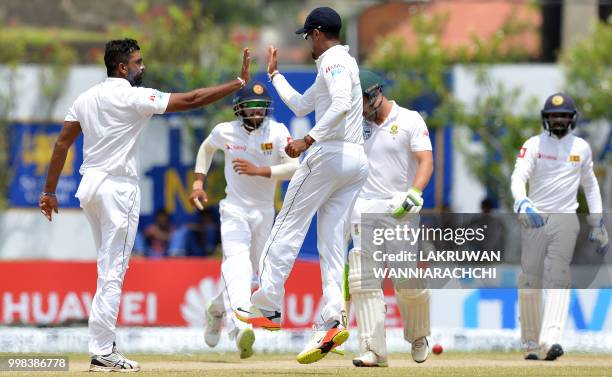 Sri Lanka's Dilruwan Perera celebrates after he dismissed South Africa's Dean Elgar during the third day of the opening Test match between Sri Lanka...