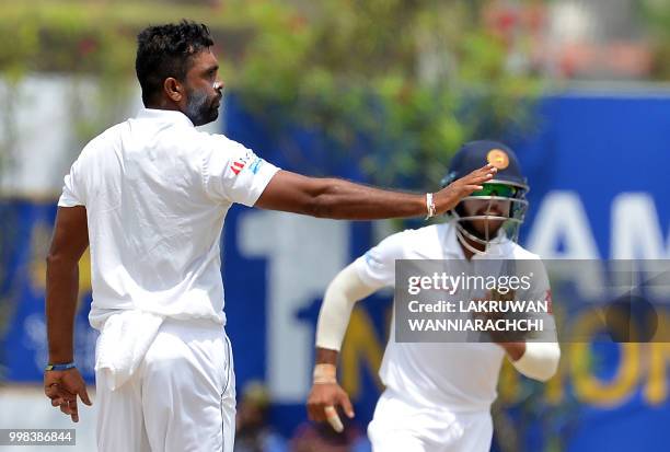 Sri Lanka's Dilruwan Perera celebrates after he dismissed South Africa's Dean Elgar during the third day of the opening Test match between Sri Lanka...