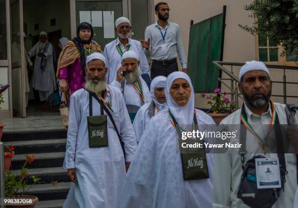 Kashmiri Muslim Hajj pilgrims walk to board a bus before departing for the annual Hajj pilgrimage to Mecca on July 14, 2018 in Srinagar, the summer...