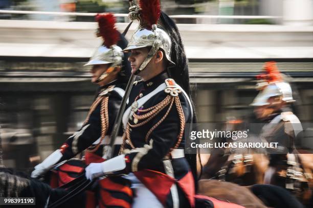 French Republican Guards arrive on horseback for the annual Bastille Day military parade on the Champs-Elysees avenue in Paris on July 14, 2018.