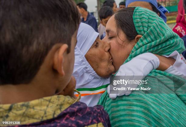 Kashmiri Muslim hajj pilgrim hugs and pecks her relative before departing for the annual Hajj pilgrimage to Mecca on July 14, 2018 in Srinagar, the...