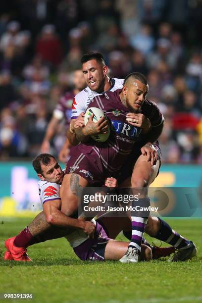 Addin Fonua-Blake of the Sea Eagles is tackled during the round 18 NRL match between the Manly Sea Eagles and the Melbourne Storm at Lottoland on...