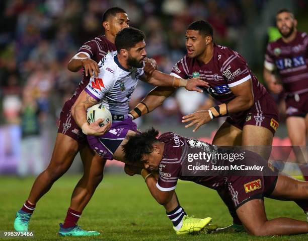 Jesse Bromwich of the Storm is tackled during the round 18 NRL match between the Manly Sea Eagles and the Melbourne Storm at Lottoland on July 14,...