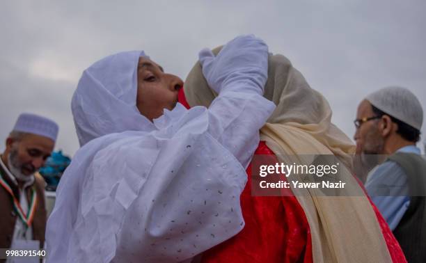 Kashmiri Muslim hajj pilgrim hugs and pecks her relative before departing for the annual Hajj pilgrimage to Mecca on July 14, 2018 in Srinagar, the...