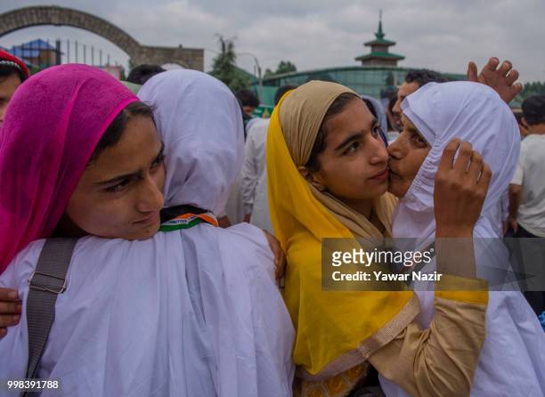 Kashmiri Muslim hajj pilgrim hugs and pecks their relatives before departing for the annual Hajj pilgrimage to Mecca on July 14, 2018 in Srinagar,...