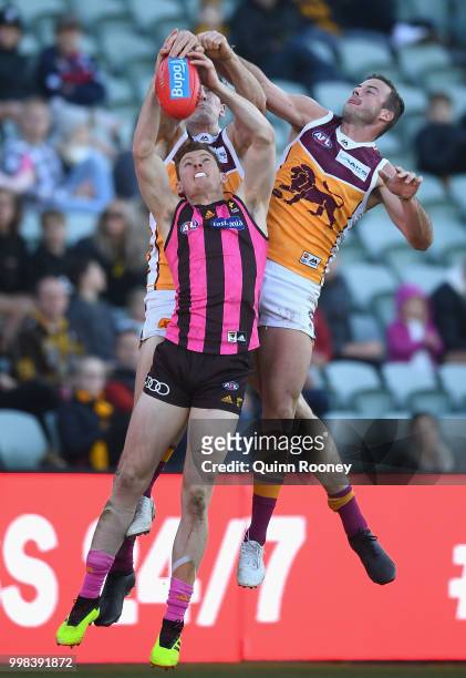 Tim O'Brien of the Hawks marks infront of Josh Walker of the Lions during the round 17 AFL match between the Hawthorn Hawks and the Brisbane Lions at...