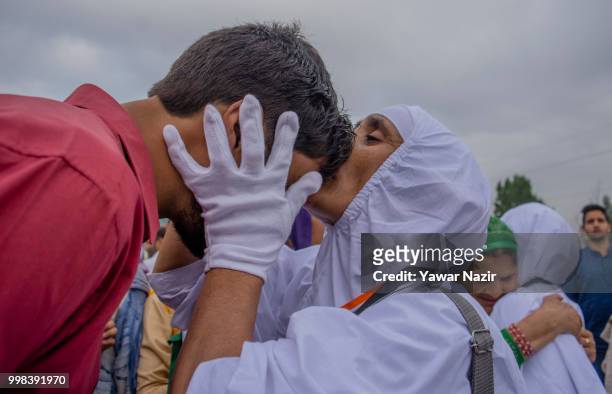 Kashmiri Muslim hajj pilgrim kisses forehead of her son before departing for the annual Hajj pilgrimage to Mecca on July 14, 2018 in Srinagar, the...