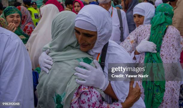 Kashmiri Muslim hajj pilgrims hugs their relatives before departing for the annual Hajj pilgrimage to Mecca on July 14, 2018 in Srinagar, the summer...