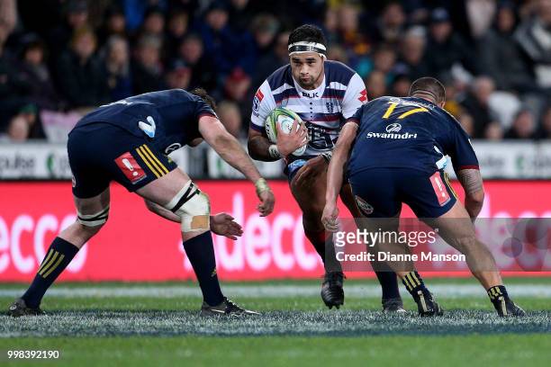 Tetera Faulkner of the Rebels is tackled by Liam Squire and Daniel Lienert-Brown of the Highlanders during the round 19 Super Rugby match between the...