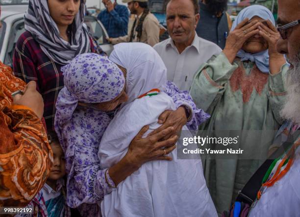 Kashmiri Muslim hajj pilgrim hugs her relative before departing for the annual Hajj pilgrimage to Mecca on July 14, 2018 in Srinagar, the summer...