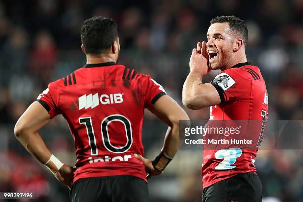Ryan Crotty of the Crusaders talks to to team mate Richie Mo'unga during the round 19 Super Rugby match between the Crusaders and the Blues at AMI...