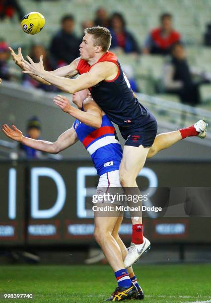 Tom McDonald of the Demons competes for the ball over Brad Lynch of the Bulldogs during the round 17 AFL match between the Melbourne Demons and the...