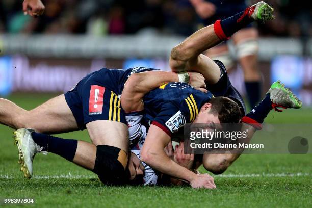 Josh McKay of the Highlanders is tackled by Jack Maddocks of the Rebels during the round 19 Super Rugby match between the Highlanders and the Rebels...