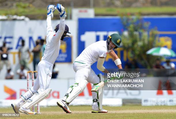 Sri Lanka's wicketkeeper Niroshan Dickwella celebrates after dismissing South Africa's captain Faf du Plessis during the third day of the opening...