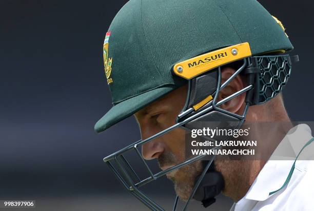 South Africa's captain Faf du Plessis walks back to the pavilion after his dismissal during the third day of the opening Test match between Sri Lanka...