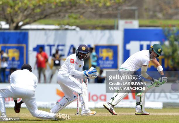 South Africa's captain Faf du Plessis watches as Sri Lanka's Angelo Mathews takes a catch to dismiss himm as wicketkeeper Niroshan Dickwella reacts,...