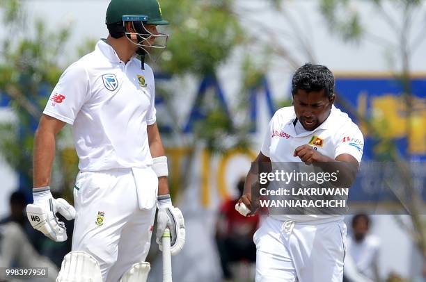 Sri Lanka's Rangana Herath celebrates after he dismissed South Africa's captain Faf du Plessis during the third day of the opening Test match between...