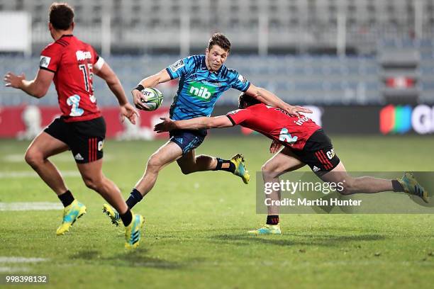 Matt Duffie of the Blues is tackled by George Bridge of the Crusaders during the round 19 Super Rugby match between the Crusaders and the Blues at...