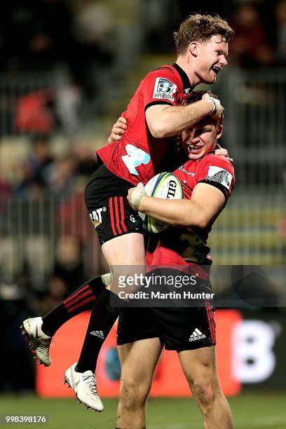 Jack Goodhue of the Crusaders celebrates with his team mate Mitchell Drummond after scoring a try during the round 19 Super Rugby match between the...